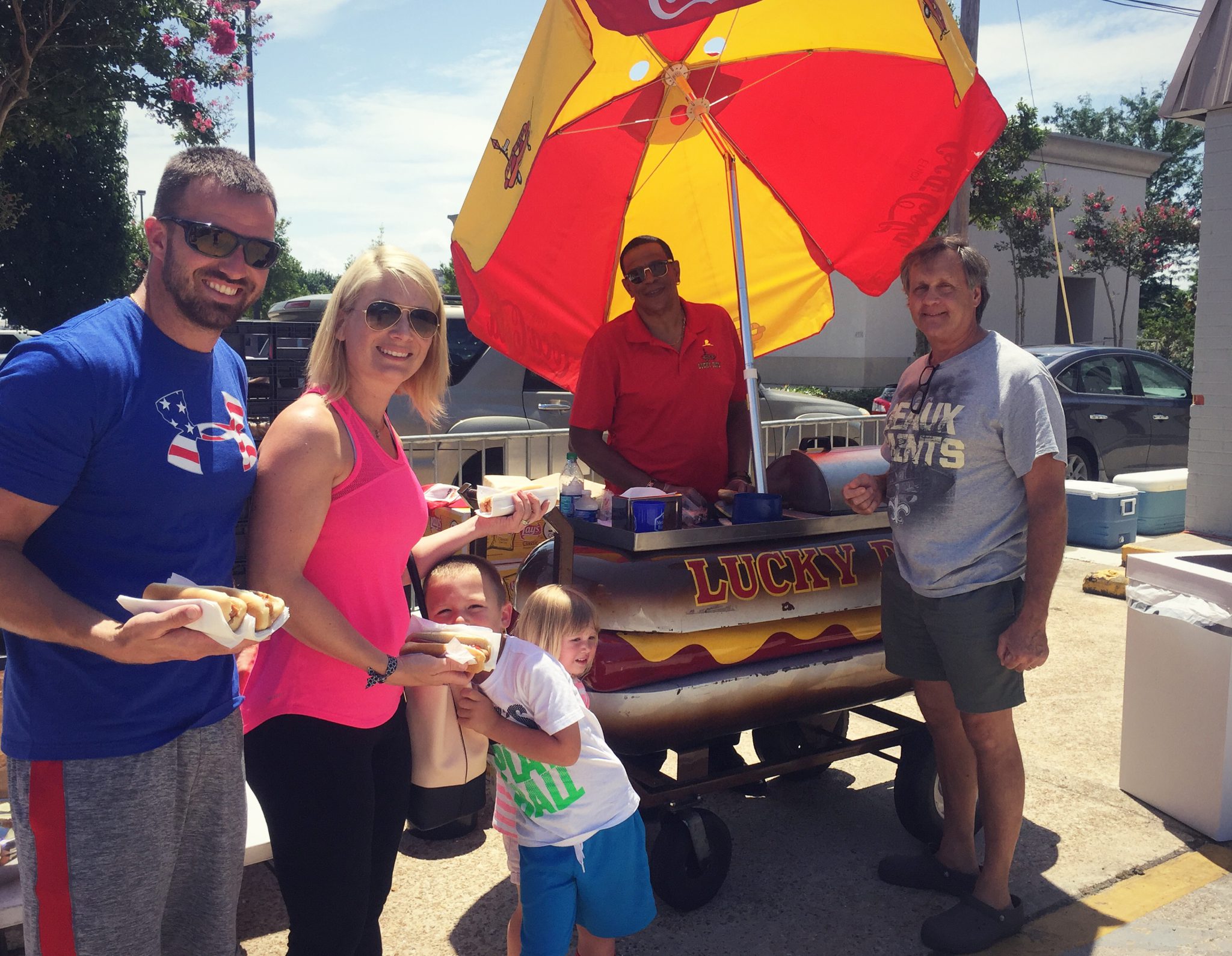 Family and friends enjoying a hot dog from Lucky Dogs at Metairie Bank's Community Shred Day.