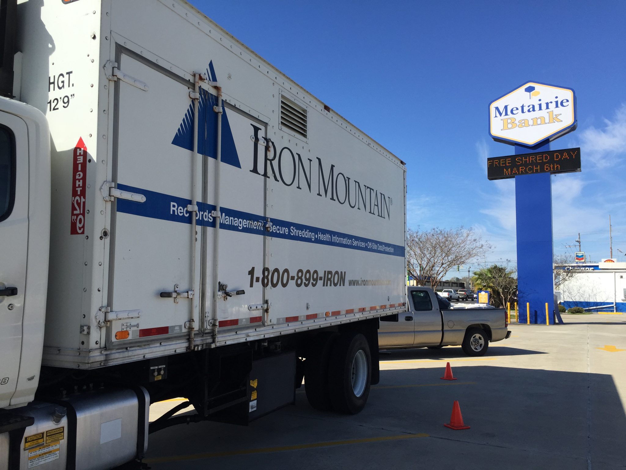 Truck with Iron Mountain shredding logo and Metairie Bank sign in the background.